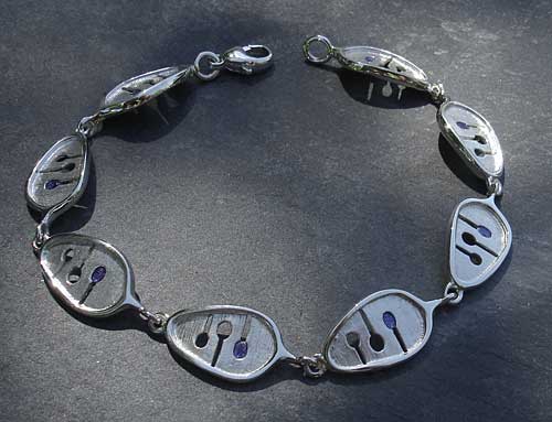 A Celtic bracelet made from sterling silver with enamel detail