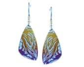 Titanium drop earrings featuring a graceful anodised wave pattern