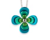 Titanium necklace featuring three four-petal flowers