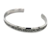 Titanium cuff bangle with a detailed natural print design