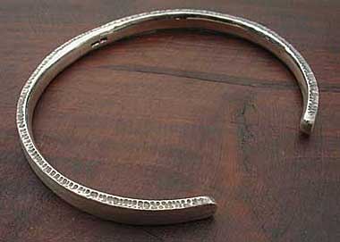 Designer silver torque bracelet