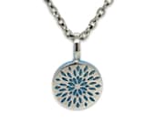 Titanium pendant featuring a deep laser-engraved blue floral design