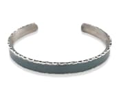 Titanium cuff bracelet featuring distinctive textured edge detailing