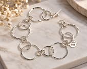 Striking contemporary bracelet featuring graduated circles of sterling silver