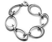 Modern link bracelet featuring a series of smooth sculptural silver links