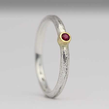 Silver engagement ring with a red ruby