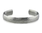 Titanium bracelet featuring a heavily textured sandstone-style centre