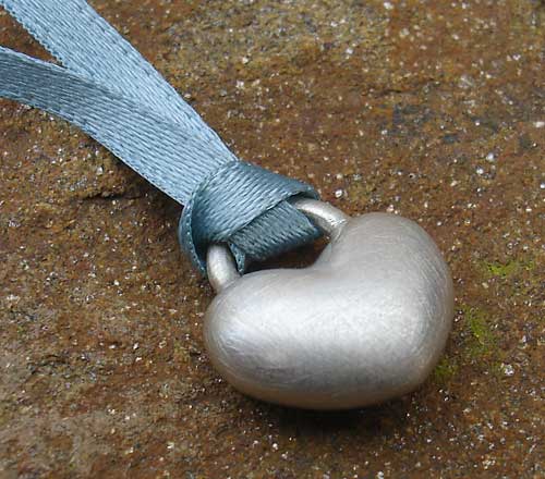 silver heart on a ribbon