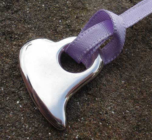 silver heart pendant on purple ribbon