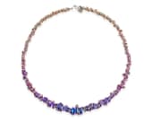 Striking necklace made of hand-formed coils of coloured titanium