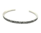 Slim titanium cuff bracelet with a natural print design