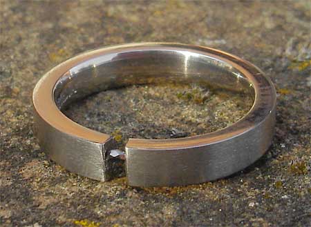Tension set black diamond titanium engagement ring