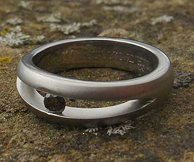 Unique black diamond tension set titanium engagement ring